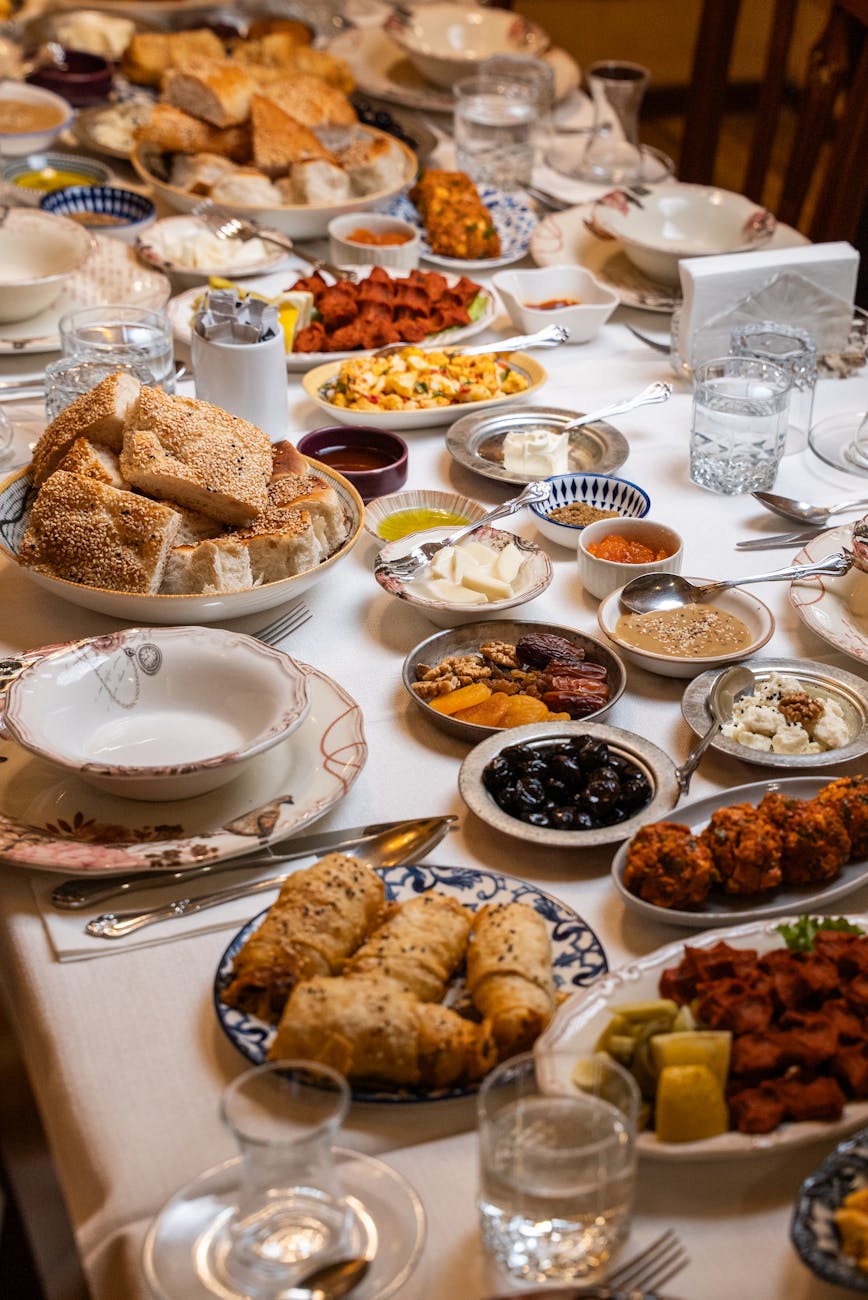 A lavish spread of traditional Turkish cuisine including bread, dips, and pastries on a dining table in Gaziantep, Türkiye.